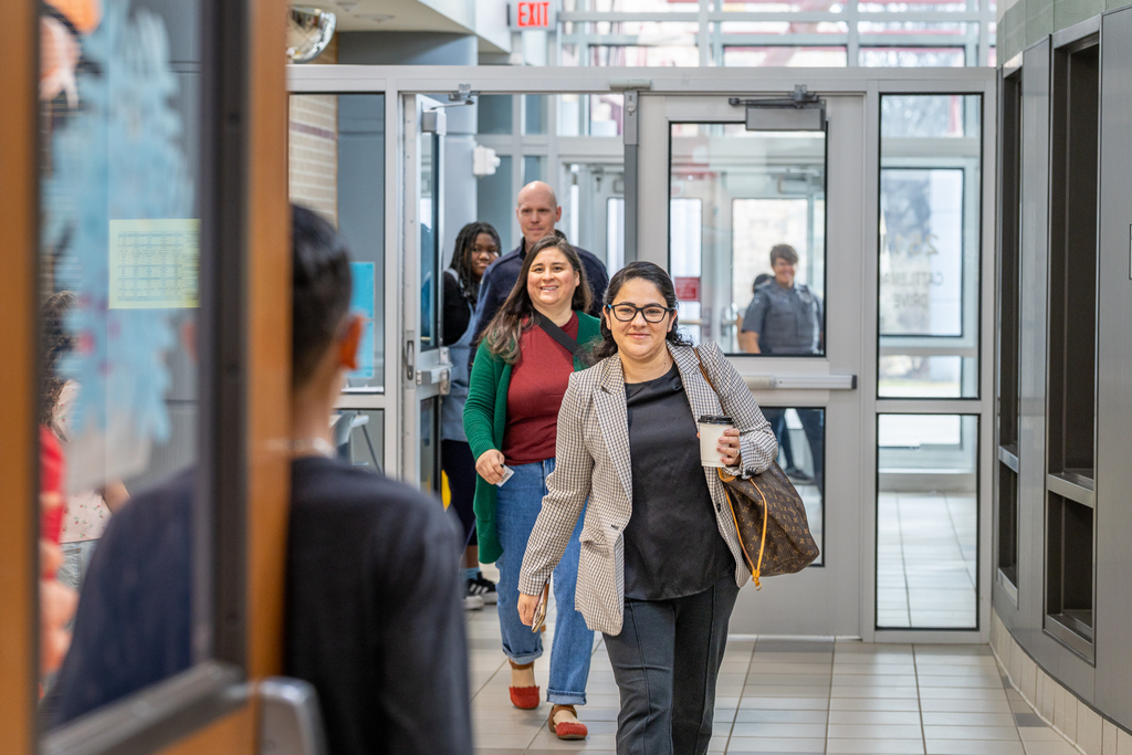 guests walking through the entrance toward library