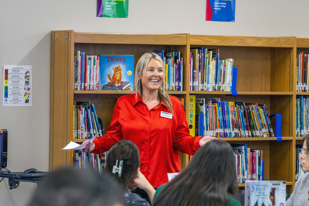 Dr. Shelly Spaulding smiling and gesturing as she speaks in front of the group