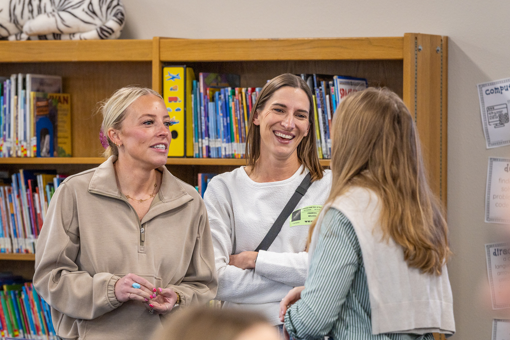 three women talking together and laughing