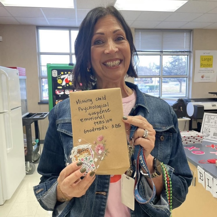 teacher holding a book