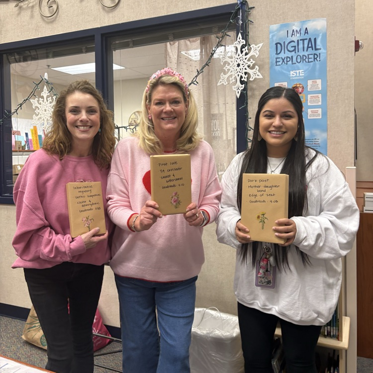 2nd grade teachers holding a book