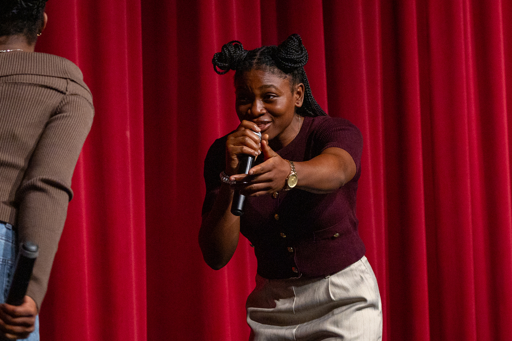 two female students onstage singing