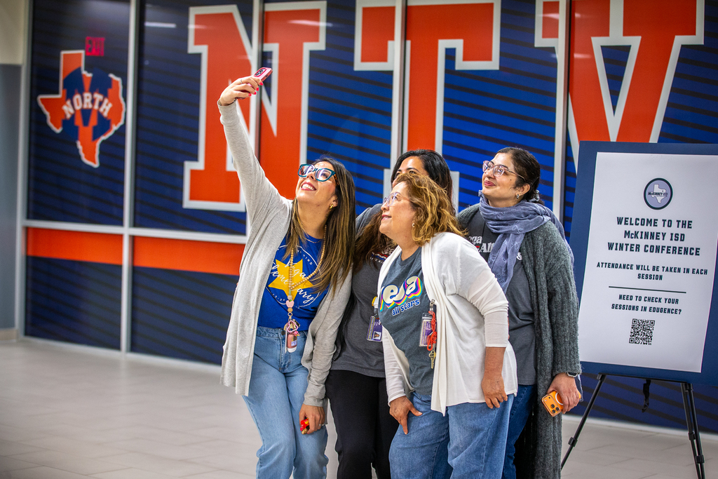 group of 4 women teachers taking a selfie together