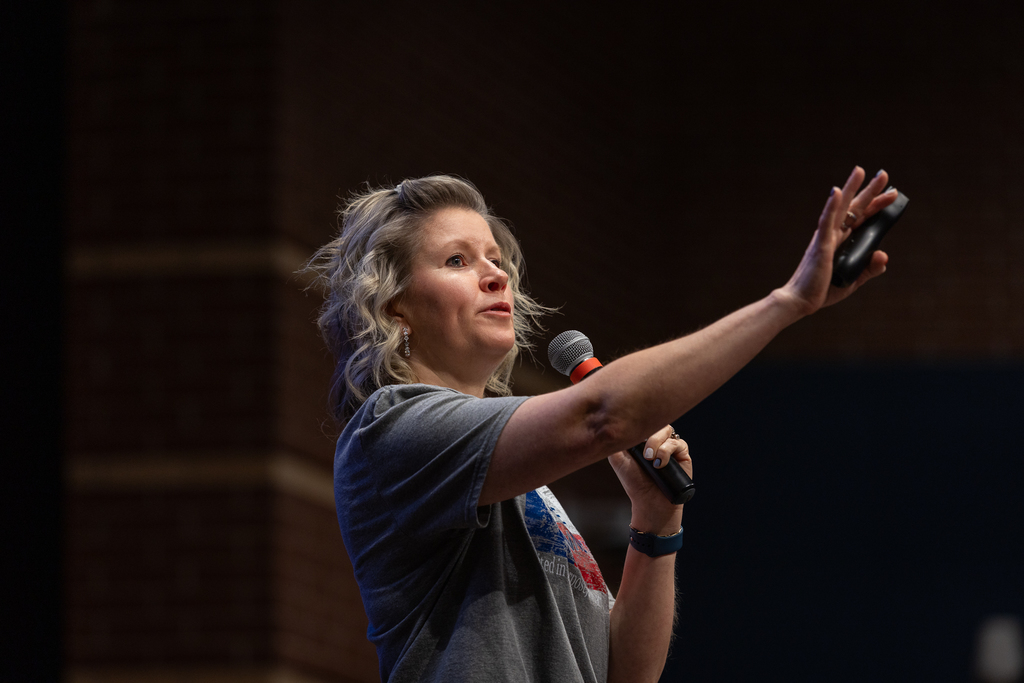woman speaking to audience from stage