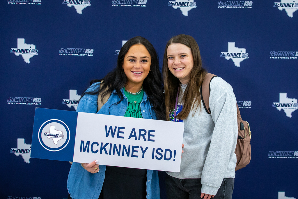 two female teachers holding we are mckinney isd sign