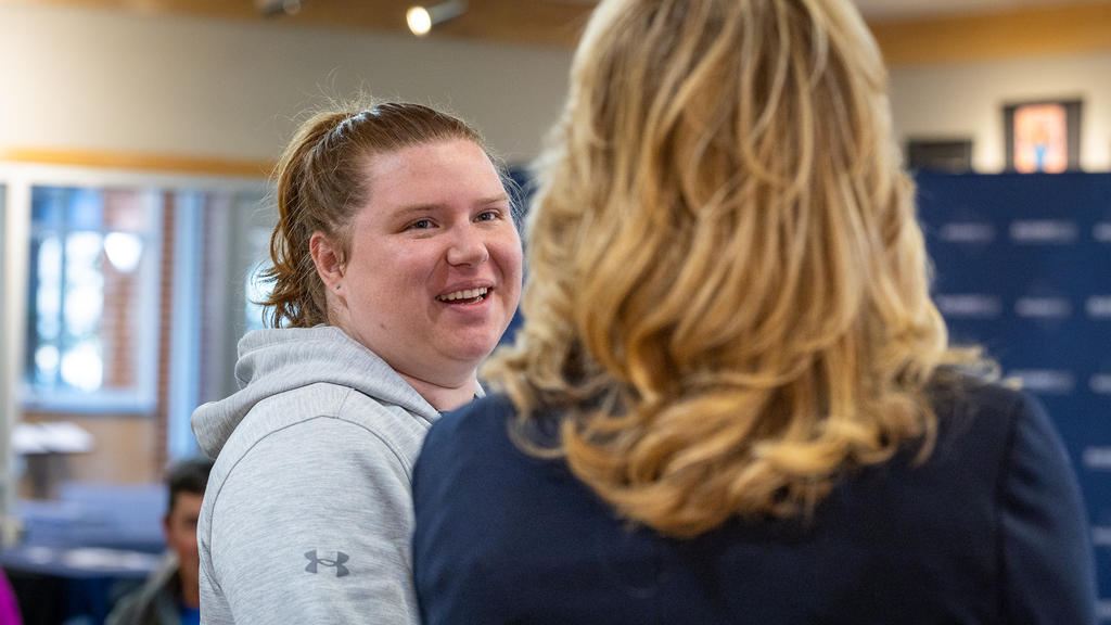 female teacher talking and smiling 