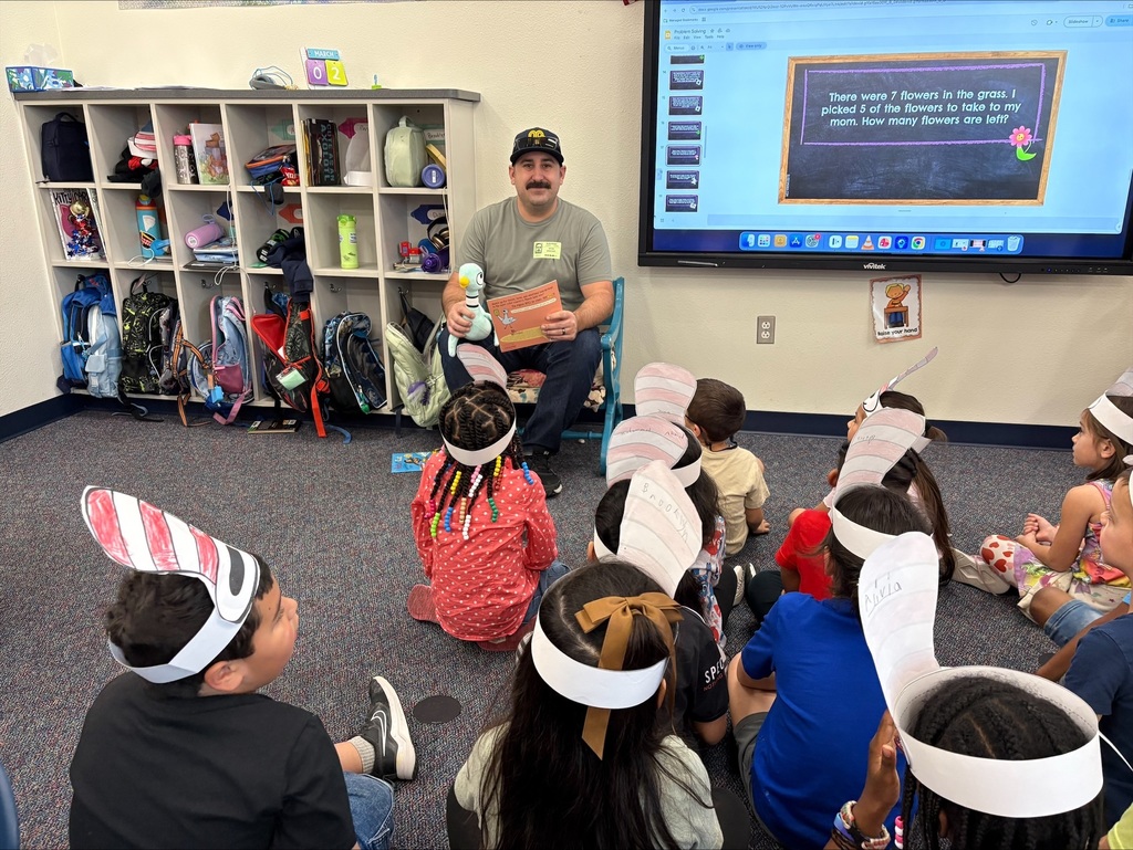 Kindergarten parent reading to a class to kickoff Read Across America.