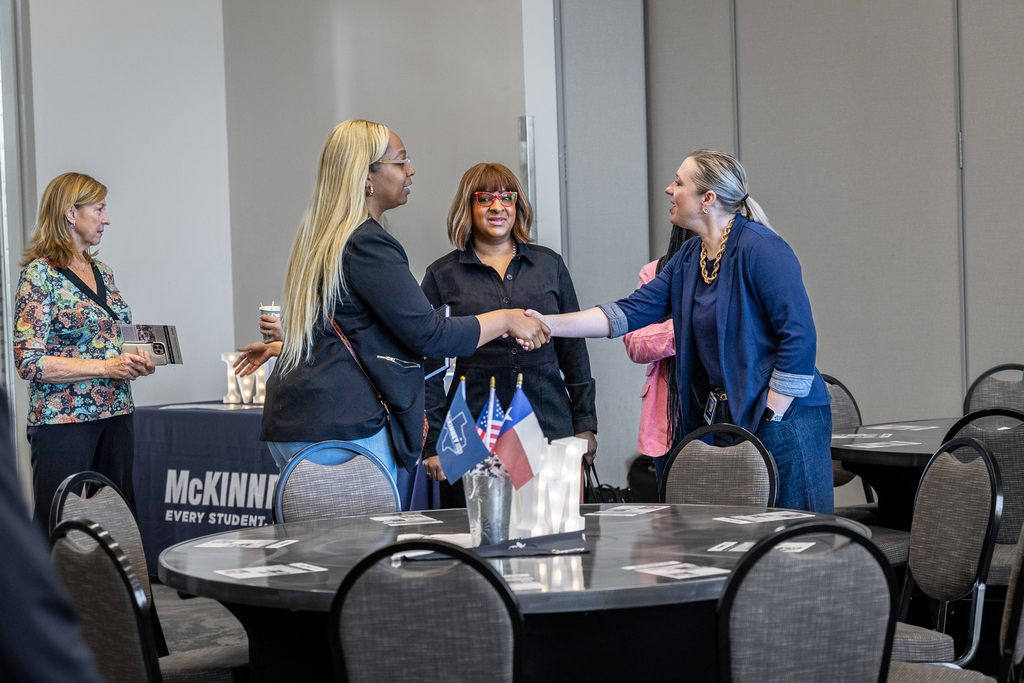 district representative shaking hands and greeting realtors as they arrive