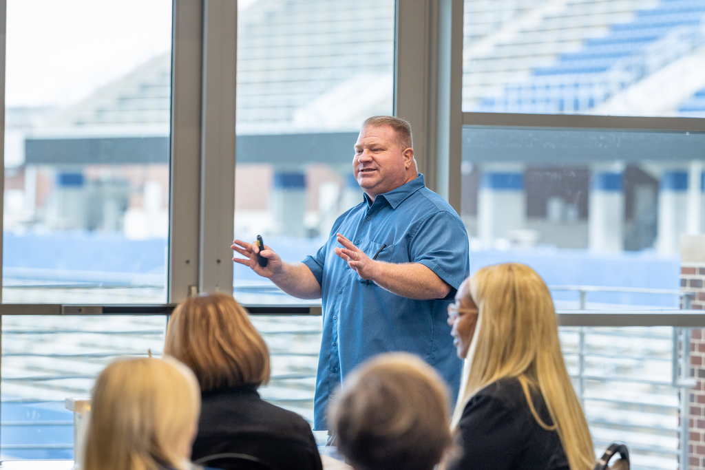 Womack speaking in front of group