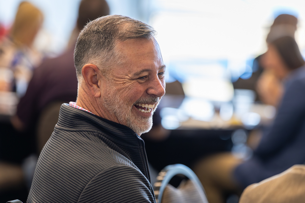 man laughing at table