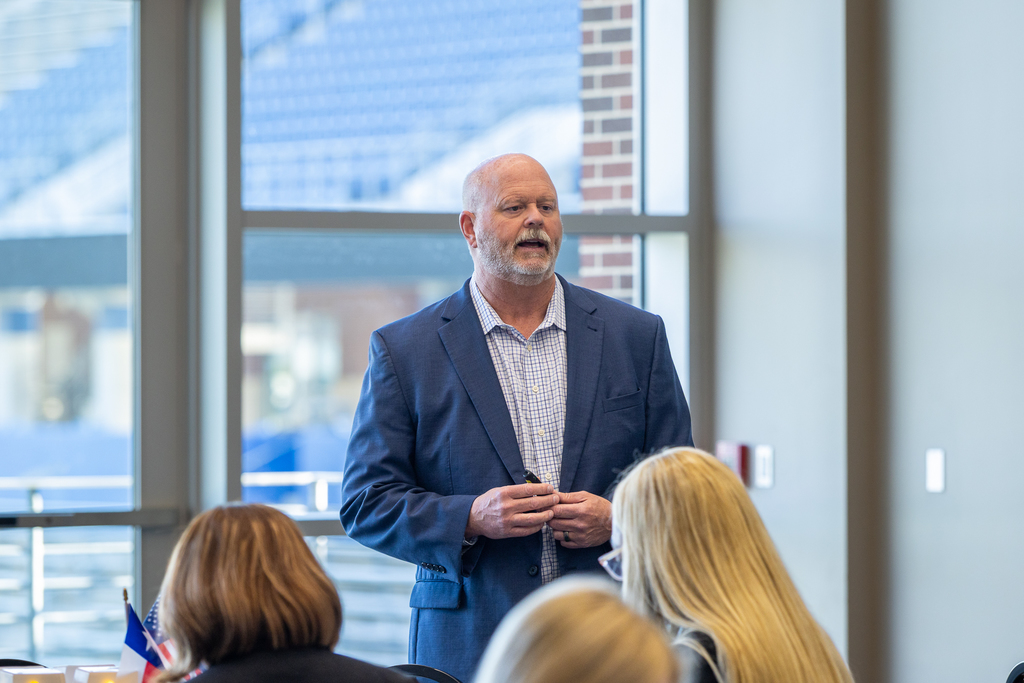 Pratt speaking in front of group