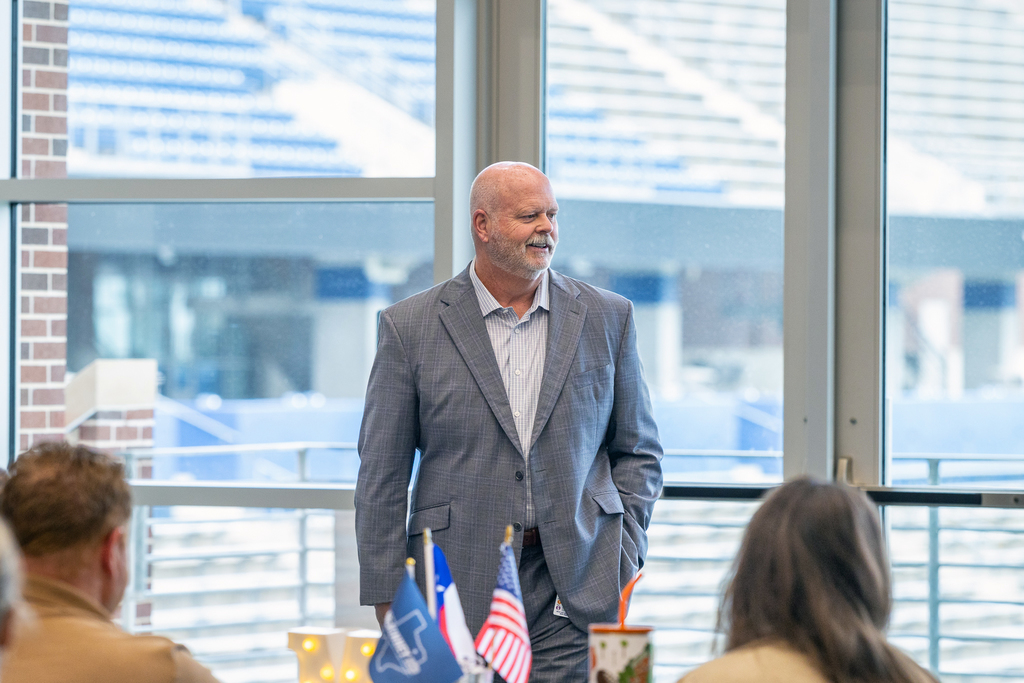 Shawn Pratt smiling as he speaks to the group