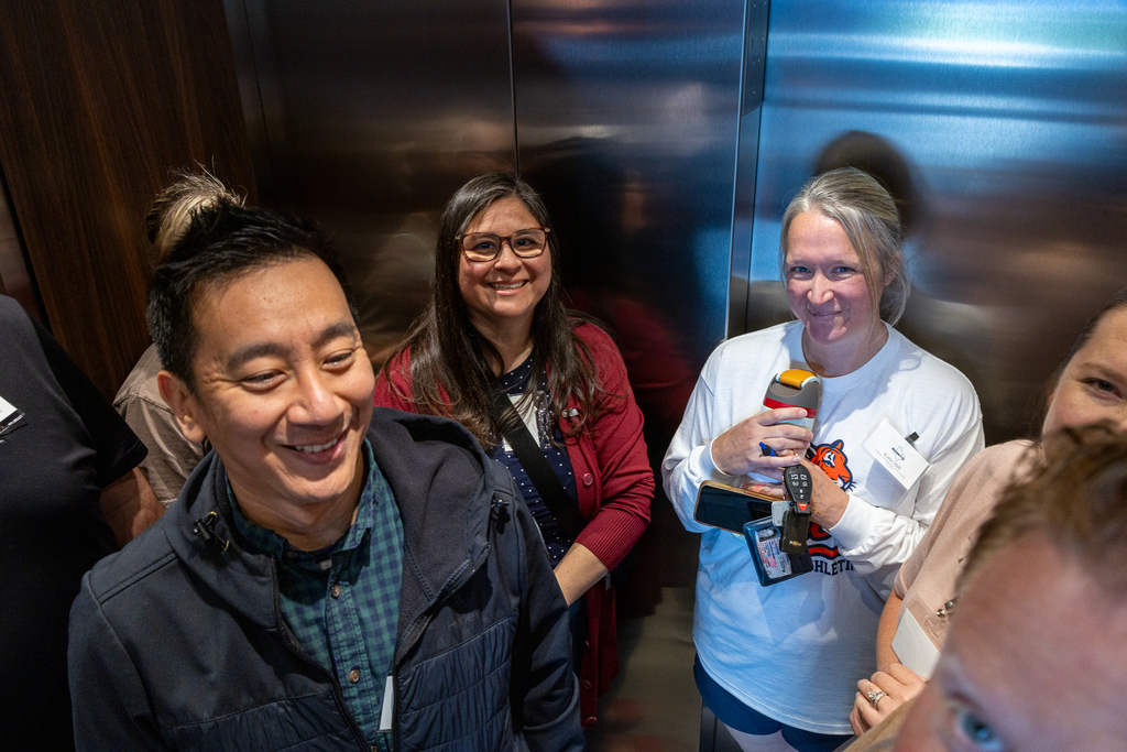 group in elevator smiling