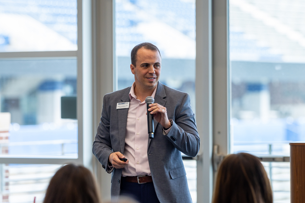 Dr. Jared Critchfield speaking with microphone in hand