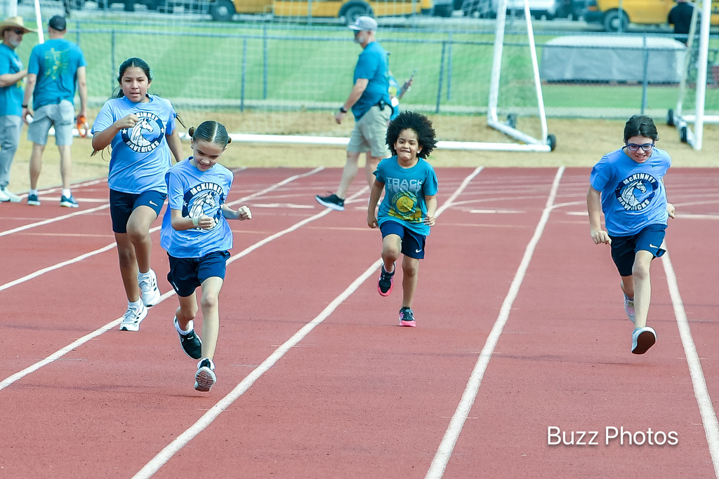 four runners on track competing in a race