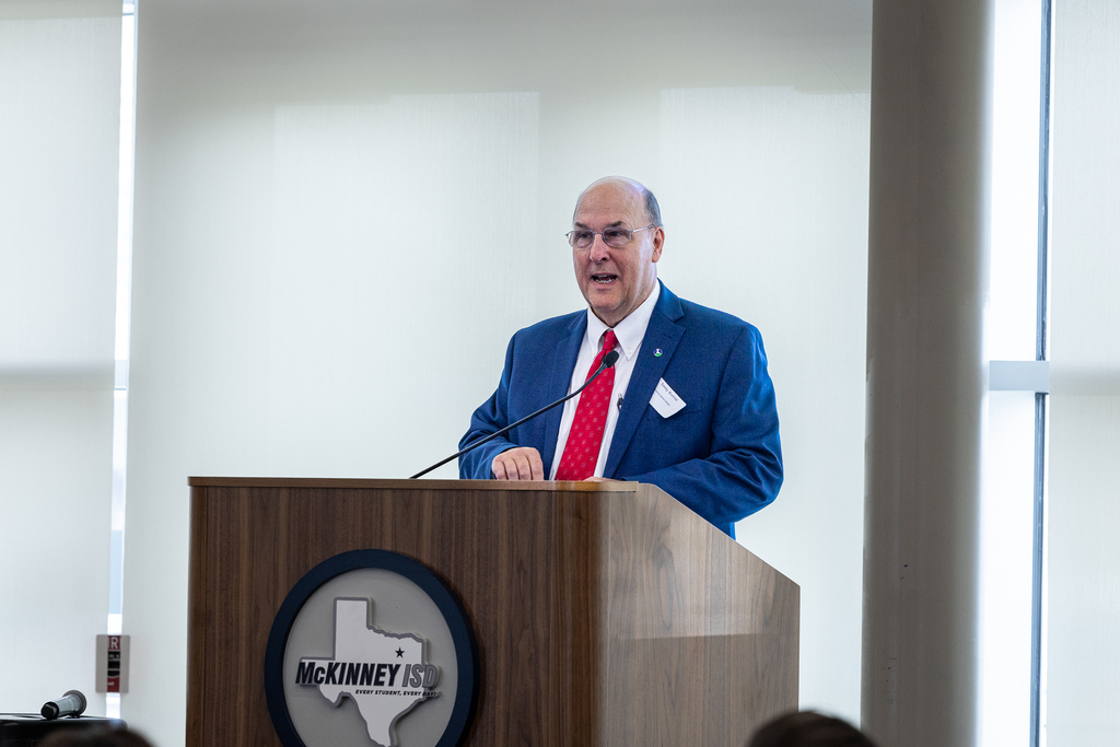 Dr. Tommy Brumett at the podium