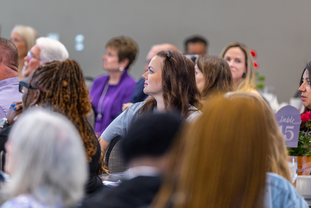 woman in crowd listening to speaker