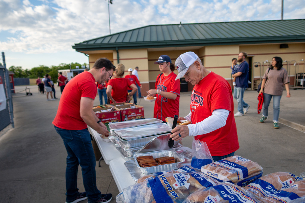 staff members get food at the cookout