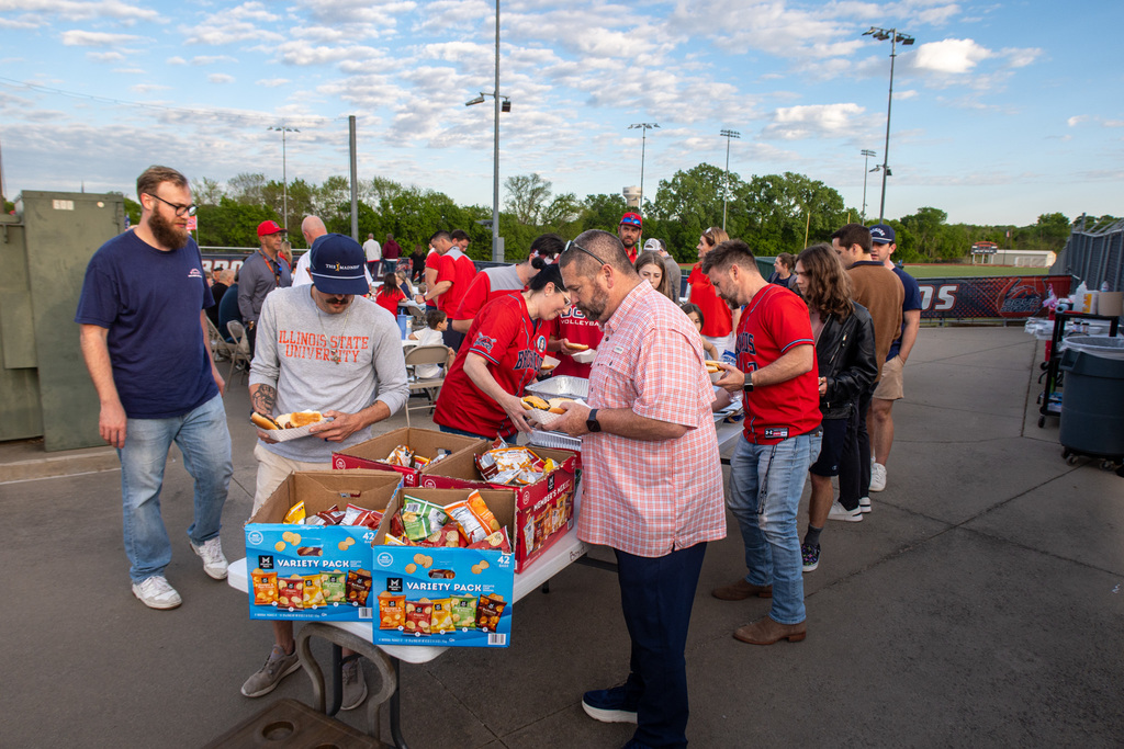 staff members get food at the cookout