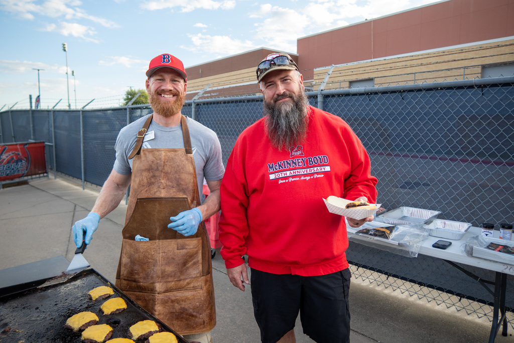 mckinney boyd staff members cook hamburgers for guests