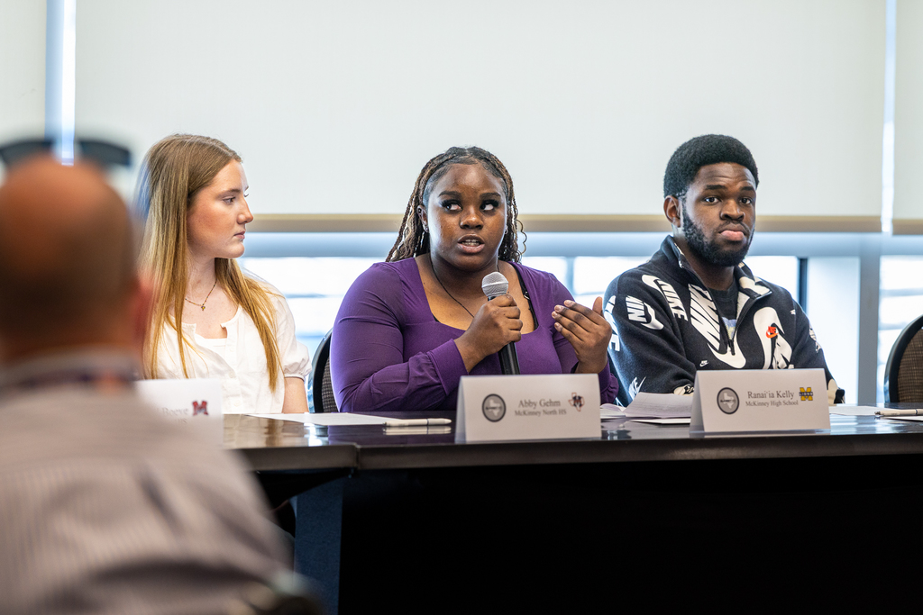 girl speaking with microphone on the student panel