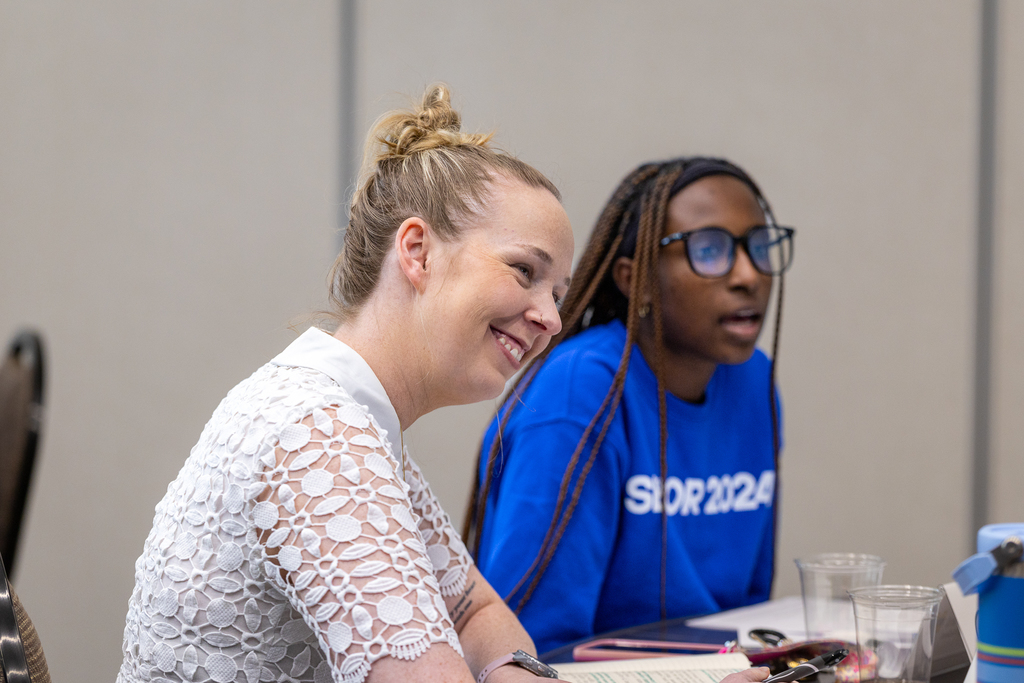 female administrator and girl talking during discussion at table