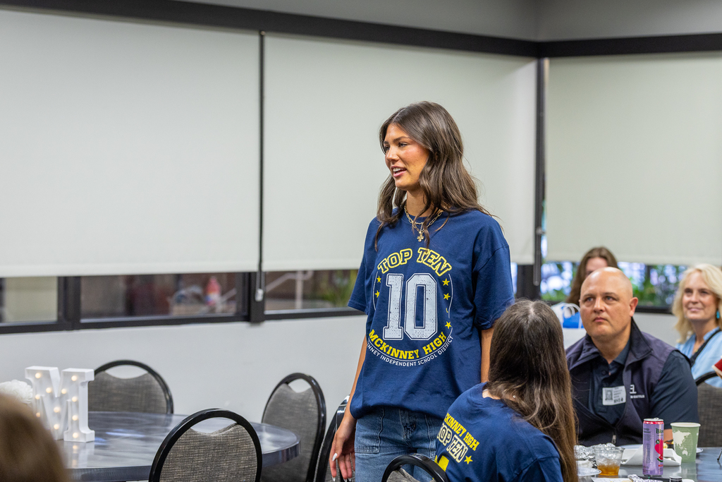 #1 student Kammie Kristufek speaking to group and standing