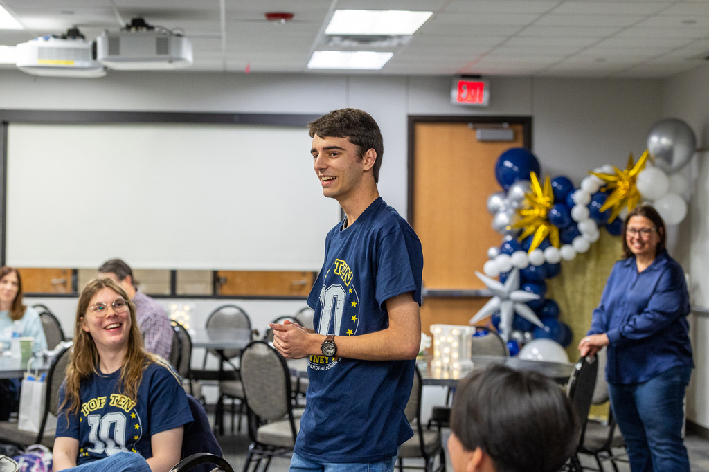 #2 student Carson Holland standing and speaking to group