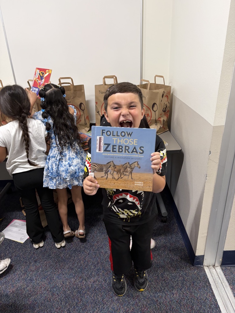 2nd graders sorting book genres.