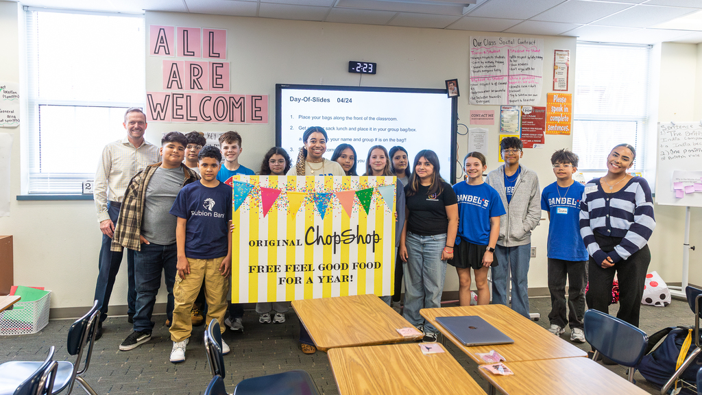 Reagan Brannon with class holding award sign from Original ChopShop