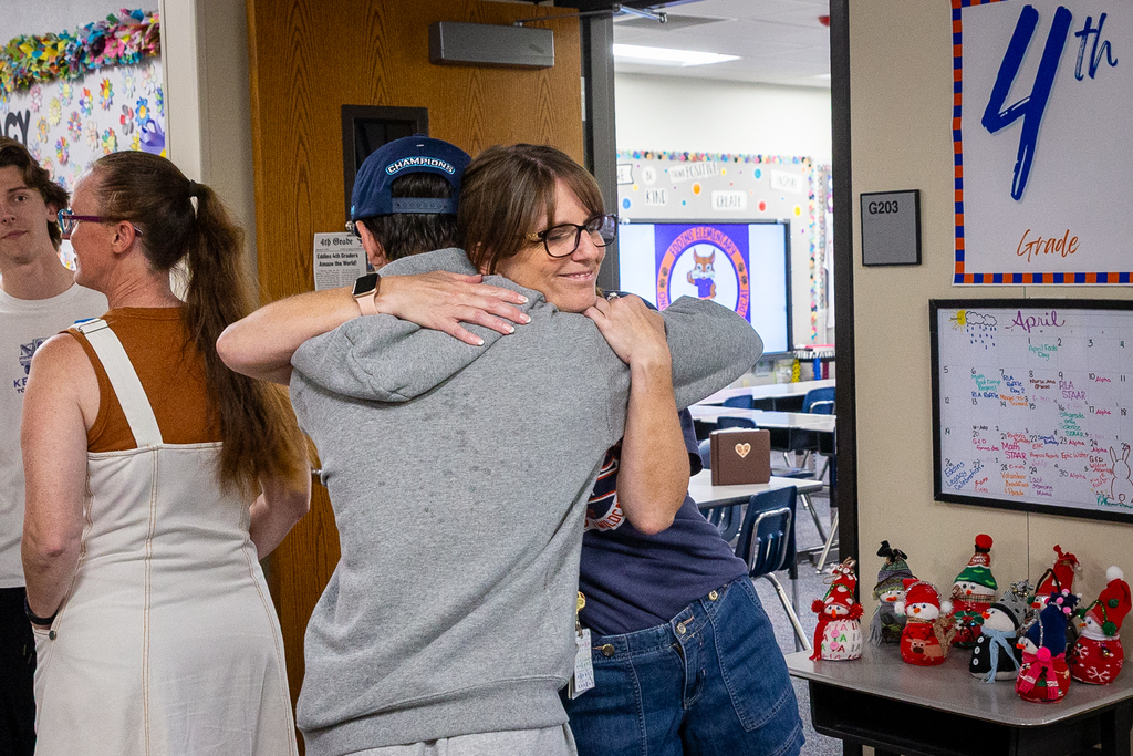 a former student a teacher hug at the eddins legacy celebration event