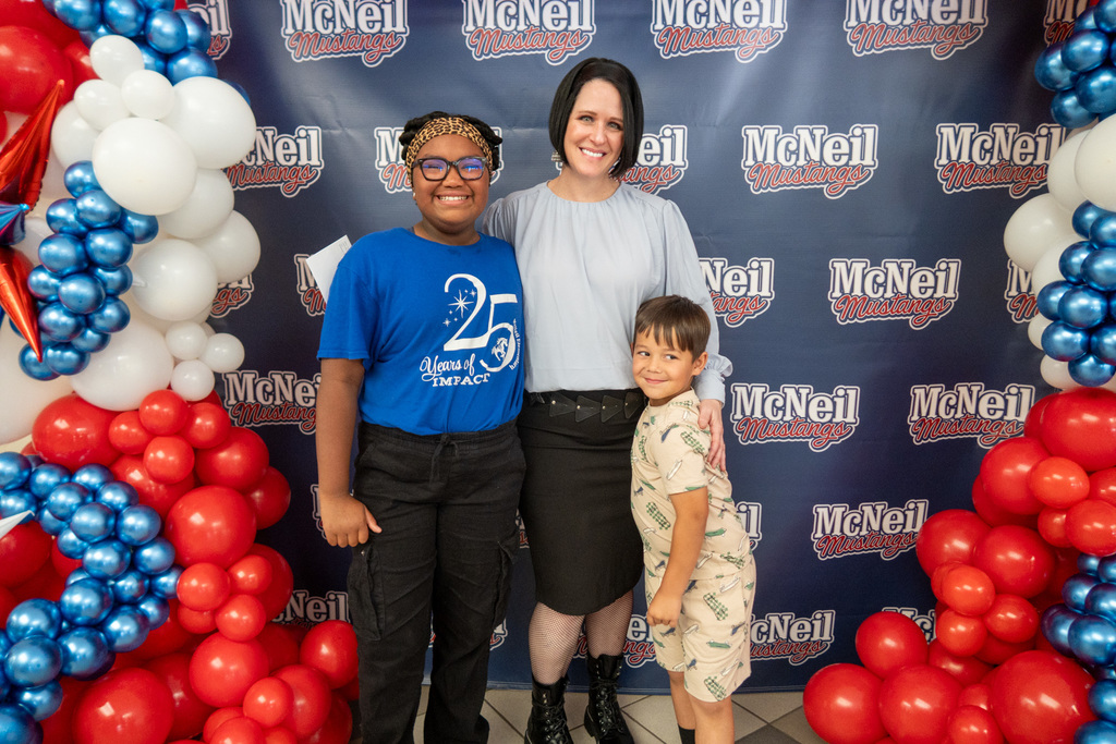 a mcneil staff member stops for a photo with a mcneil student 