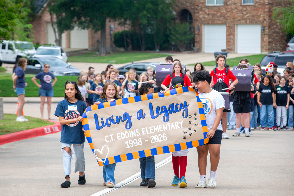 students carry a banner for a living legacy c.t. eddins elementary