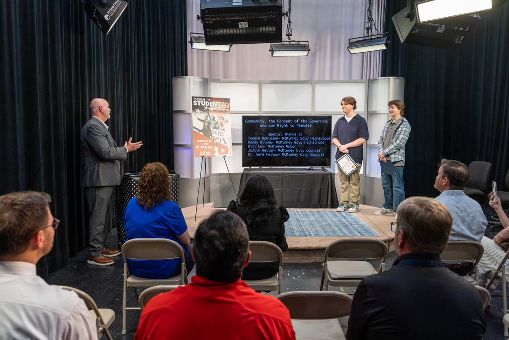 Pratt speaking to Ean and Tyler from podium