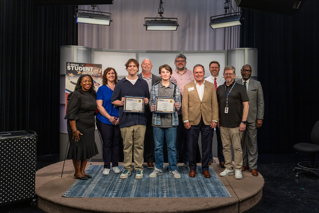 group photo of C-SPAN Media Relations Specialist Robin Newton, Boyd Video Production Teacher Tamara Robinson, Ean Scott, McKinney ISD Superintendent Shawn Pratt, Tyler Jorgenson, McKinney City Council Member Justin Beller, Mayor Bill Cox, Boyd Principal David Hodum, Boyd Government Teacher Randy Bilyeu and Clem Maddox from Charter Communications