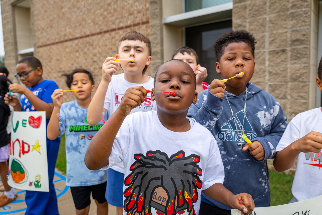 Boys with bubble blowers about to blow bubbles
