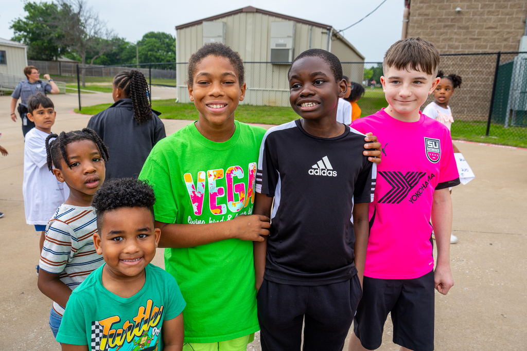 Group of boys standing with student with special needs