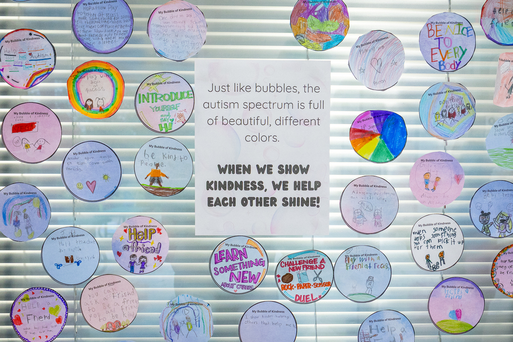 wall display of bubble art with messages about kindness for autism awareness