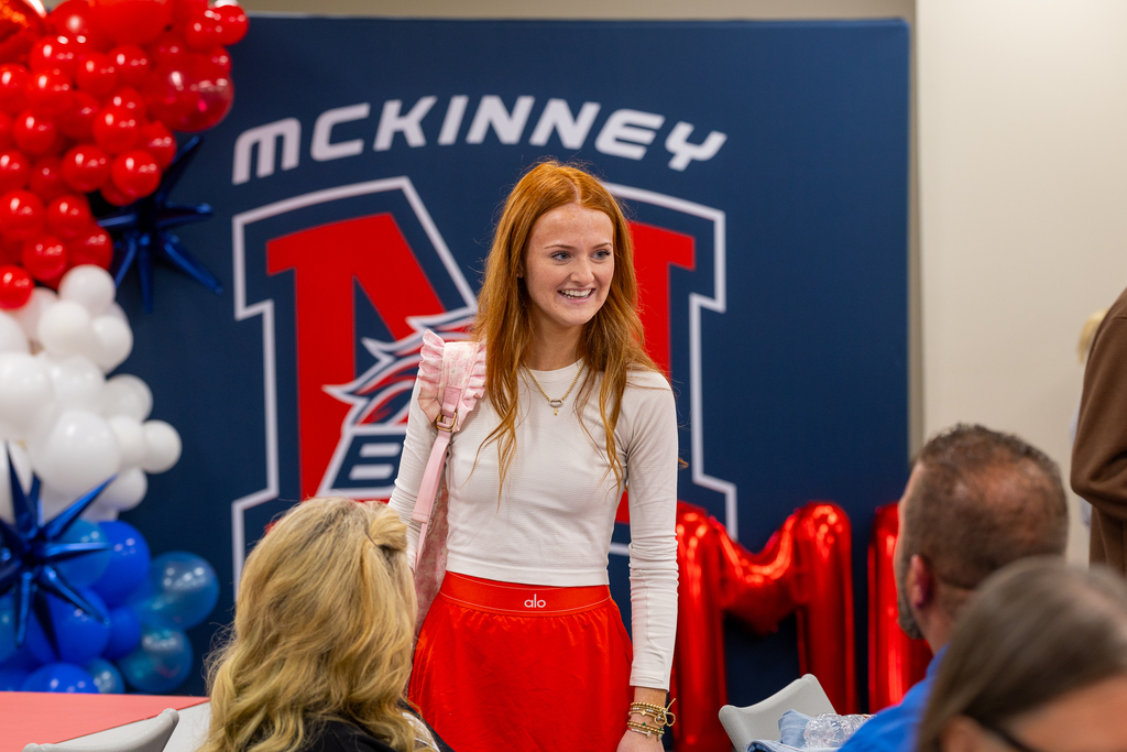 student smiling and talking to parents