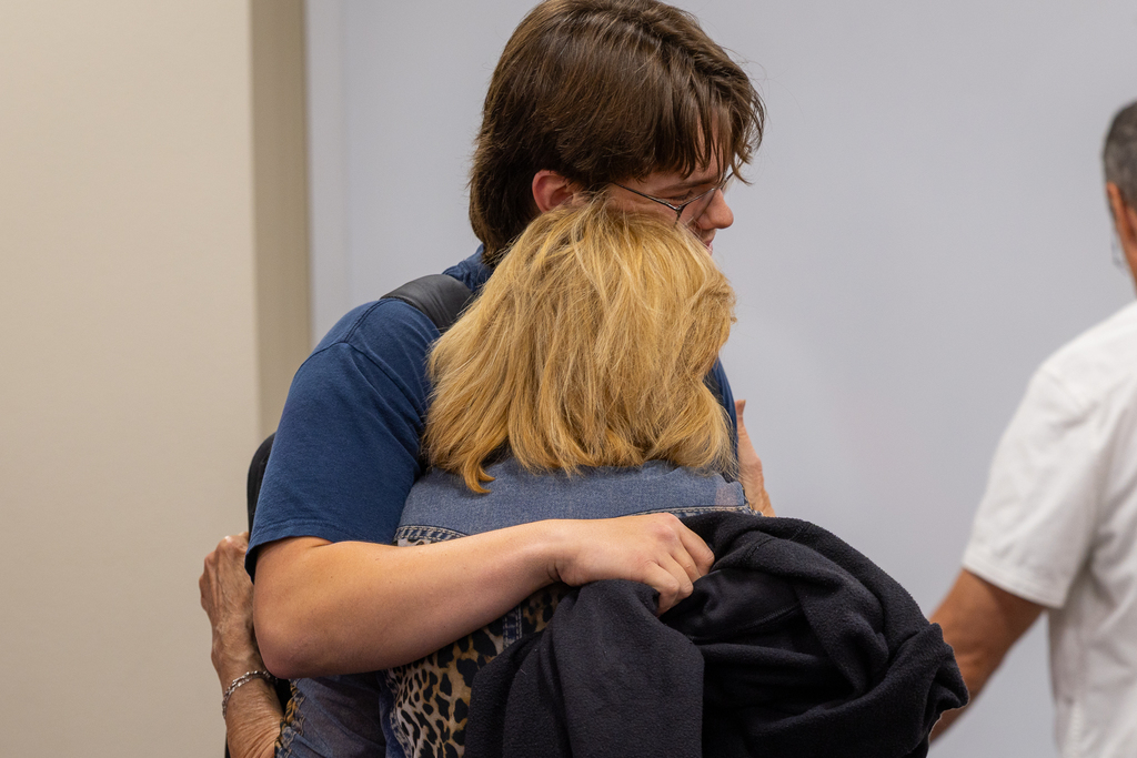 Student getting big hug from mom