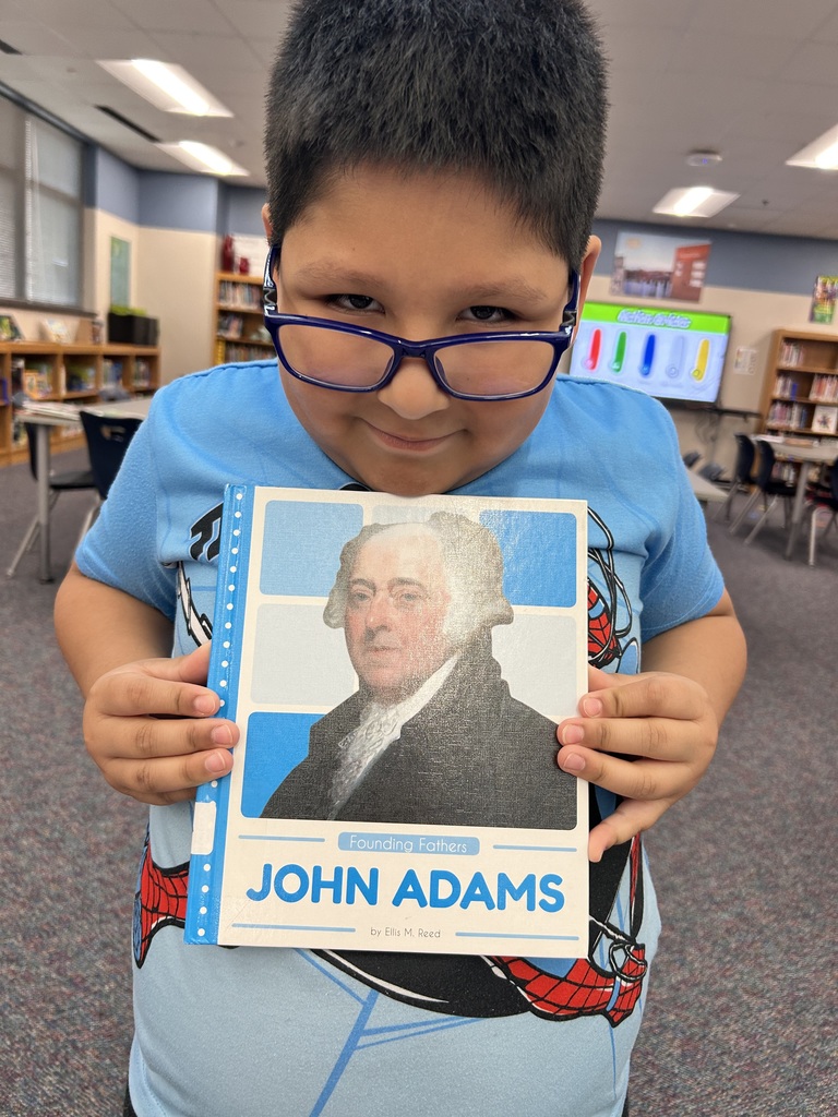 Third grader using a new biography for research
