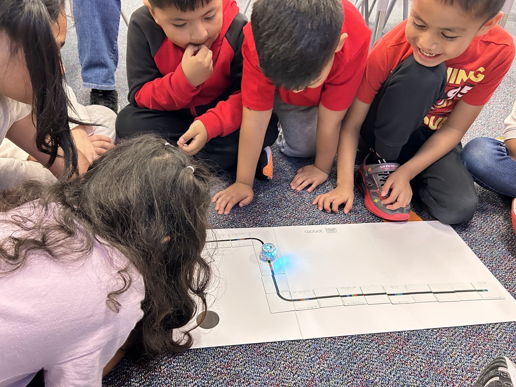 Students using coding cards to code practice computer science concepts.