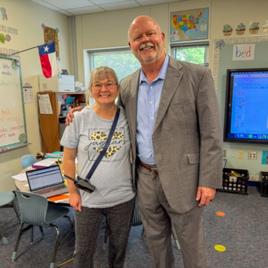 superintendent shawn pratt takes a photo with a teacher 