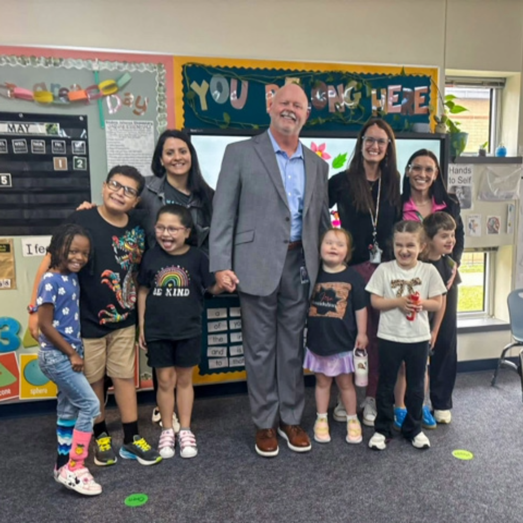 superintendent shawn pratt takes a photo with students 