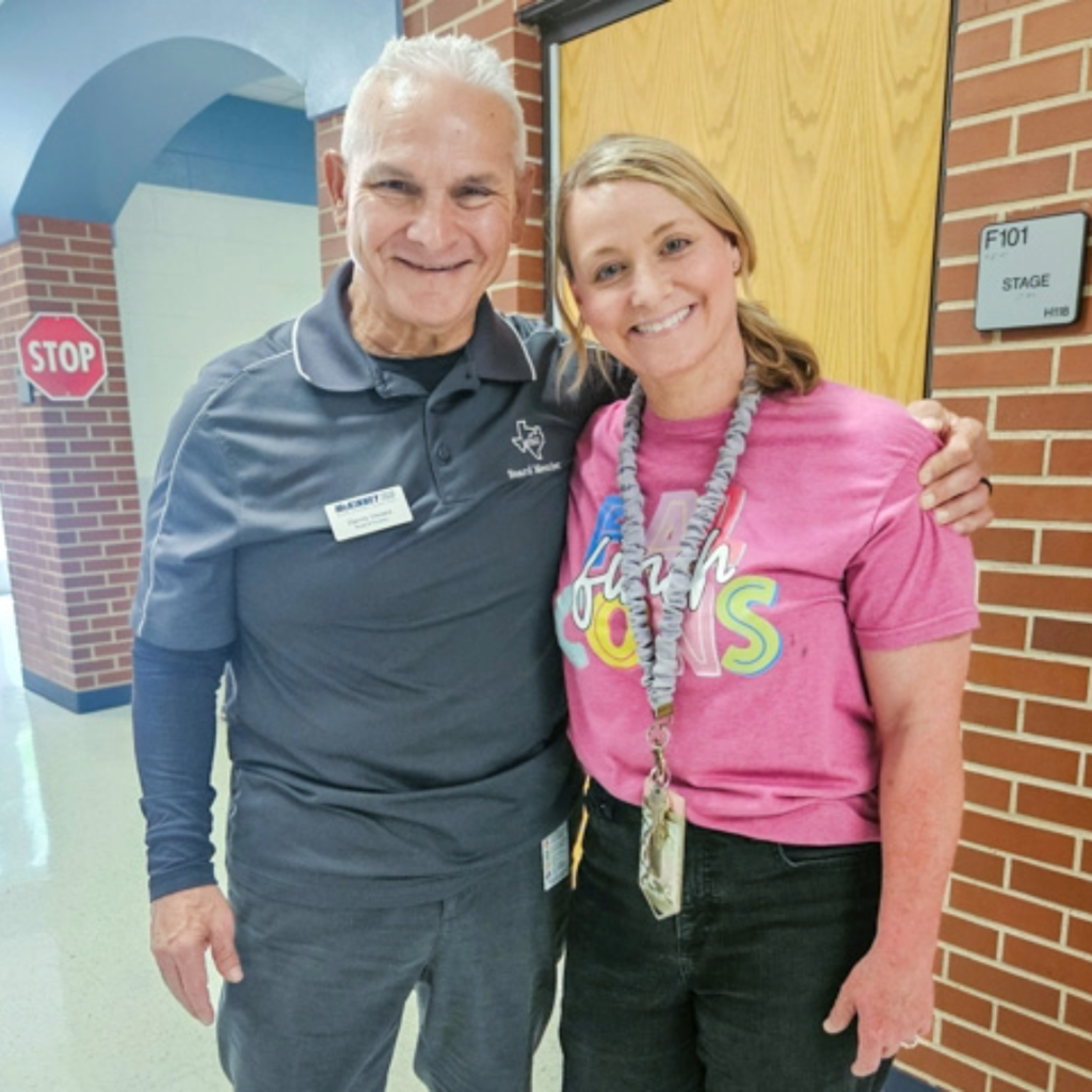 board member harvey oaxaca takes a photo with a teacher 