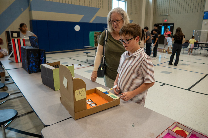 a student plays a game at malvern steam night 