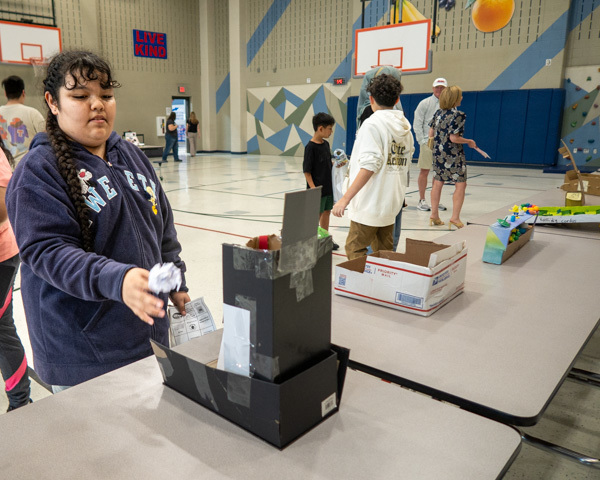 a student plays a game at malvern steam night 