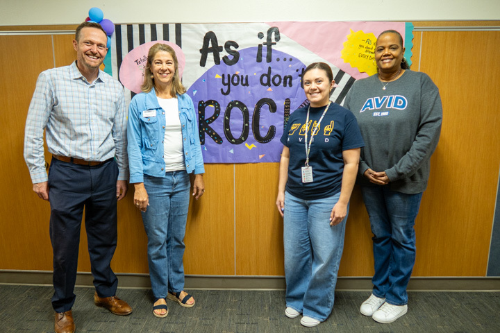 board member stephanie odell takes a photo with faubion teachers 