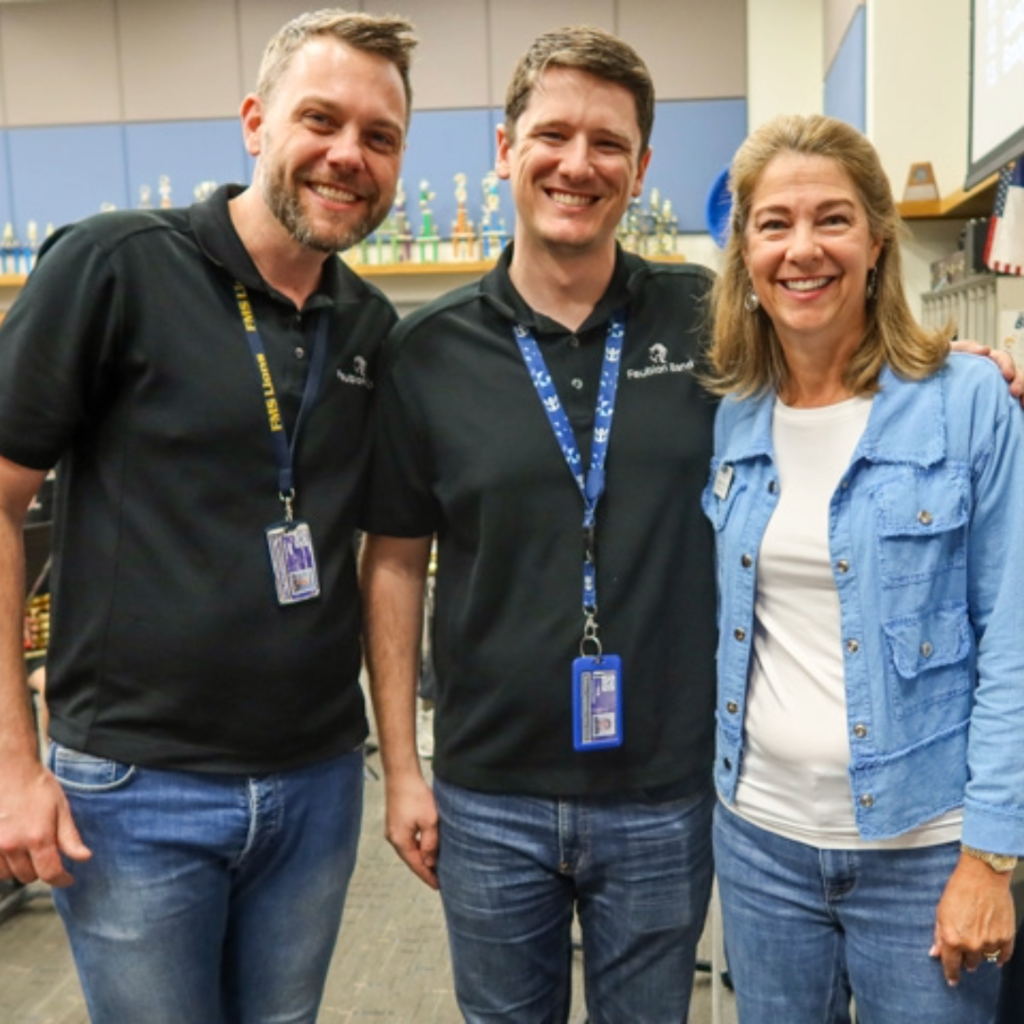 board member stephanie odell takes a photo with faubion teachers 