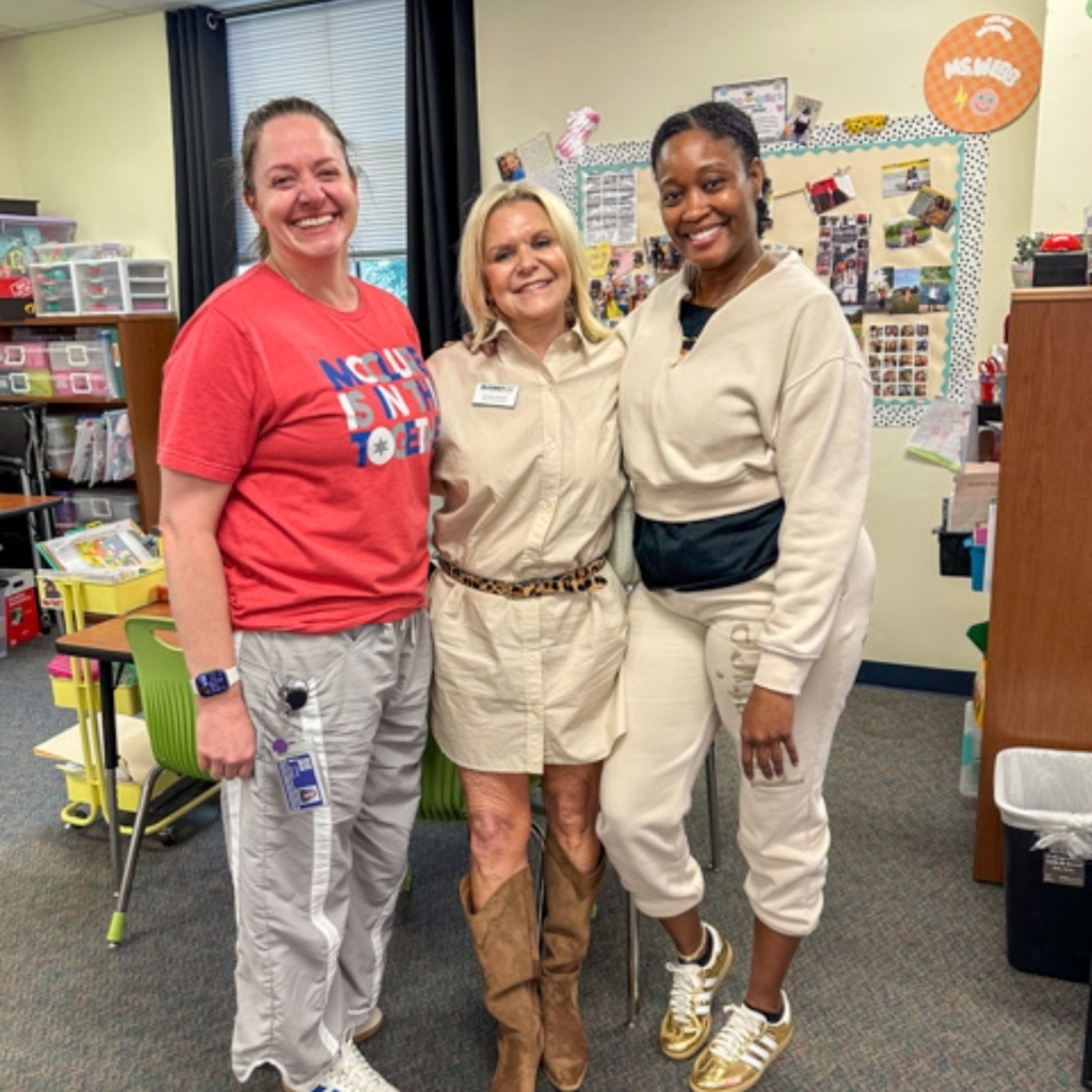 melanie raleeh takes a photo with mcclure teachers 